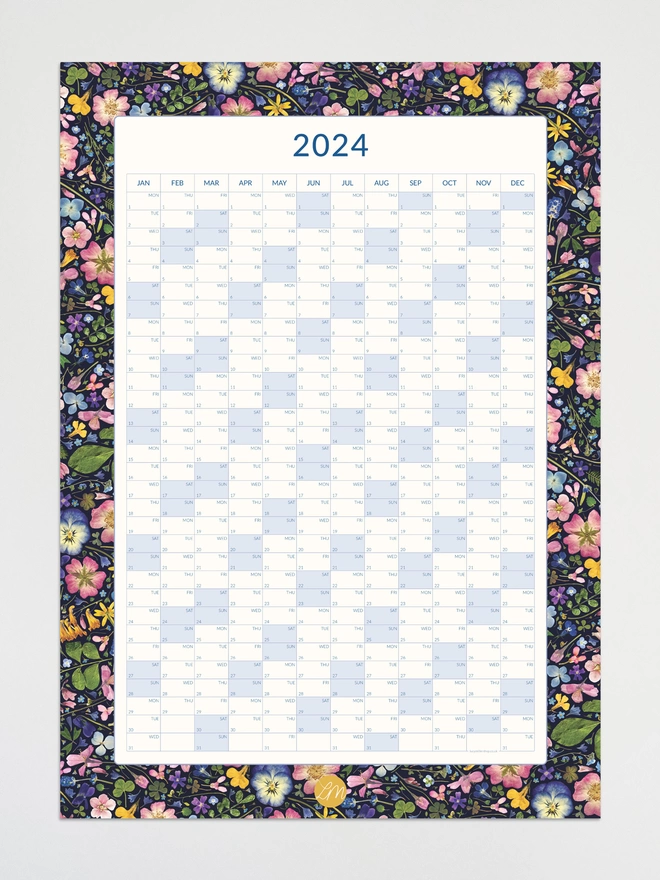 An image of a wall planner with a pretty pressed floral border