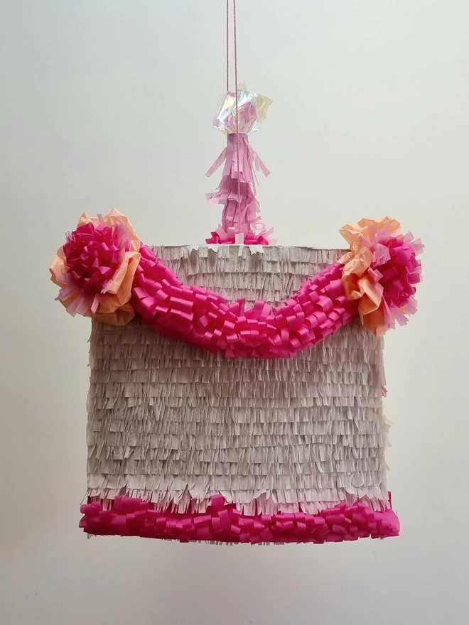 back view of the cake slice pinata with pink and white icing