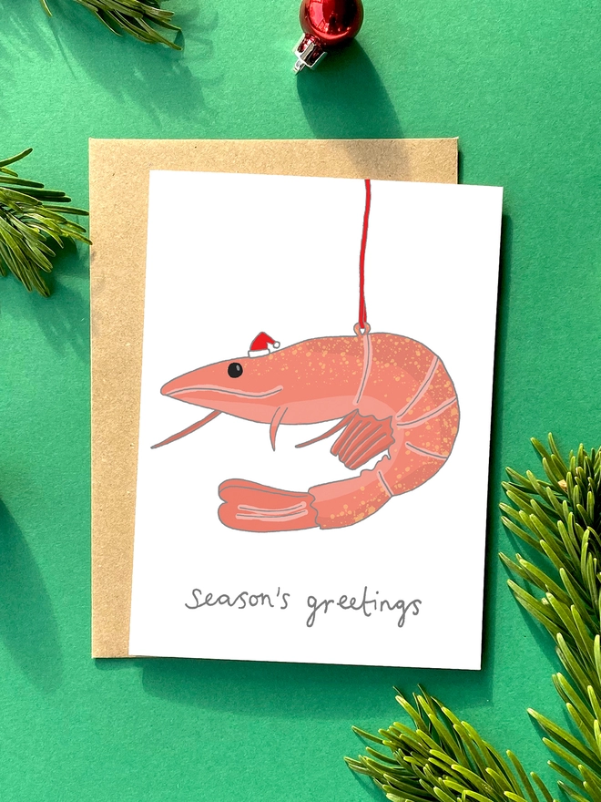 Festive Christmas card featuring a kitsch prawn decoration 