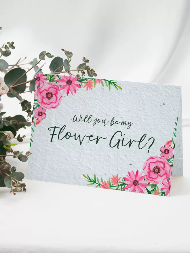 Seeded Paper Greeting Card featuring floral illustrations with ‘Will you be my Flower Girl?’ written in the centre with a bunch of flowers in the background