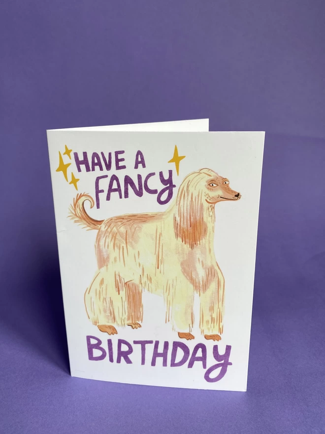 Illustrated birthday card with blonde afghan hound that reads have a fancy birthday, A6 greeting card for dog lovers