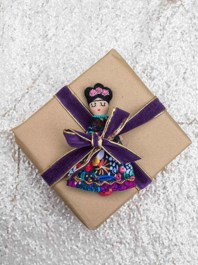 Frida Khalo Inspired mini doll as a present wrapper.