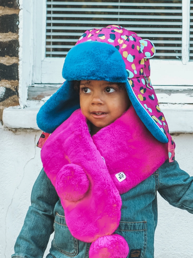 Girl wearing winter pinkkin trapper hat