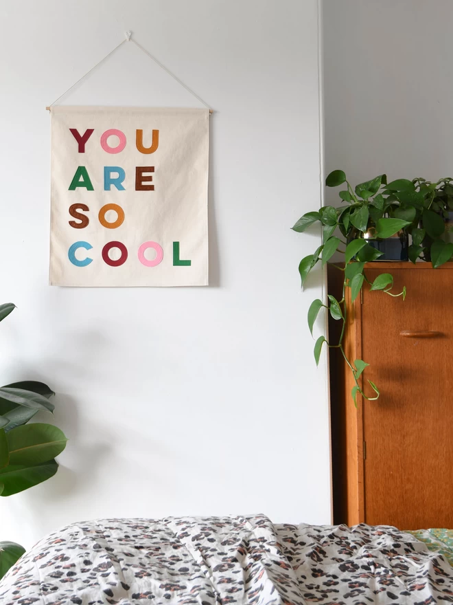 Canvas wall banner with the words you are so cool sewn on in felt letters.