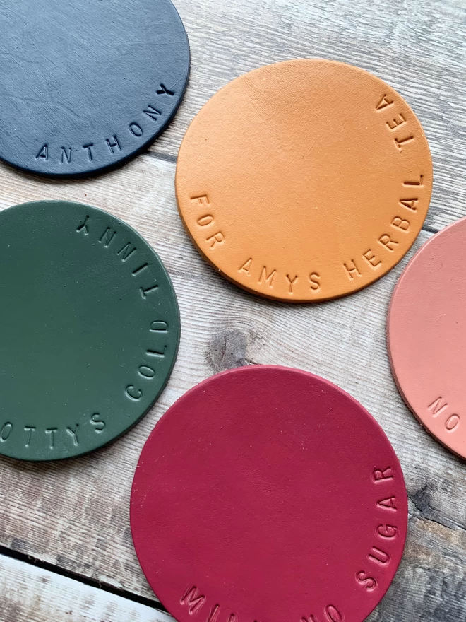 Hand stamped leather coasters with personalised messages stamped on.