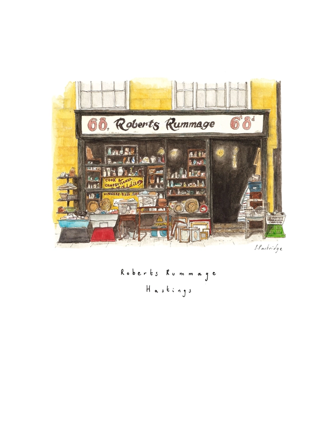 Watercolour illustration of Robert’s Rummage antique shop in Hastings, a black shopfront on a yellow building, the shop window is packed and antiques and bric a brac spill out into the street infront of the shop. The watercolour painting picks out tiny details of the scene and sits on a white piece of paper with the name written below. 