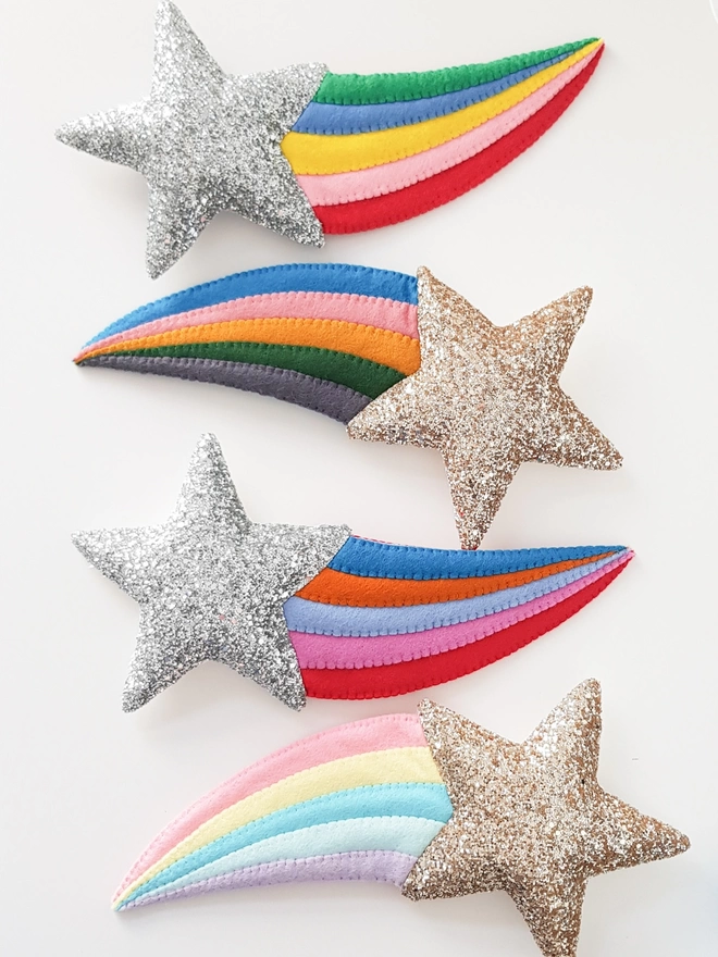 Four felt shooting stars with alternating gold and silver glitter stars