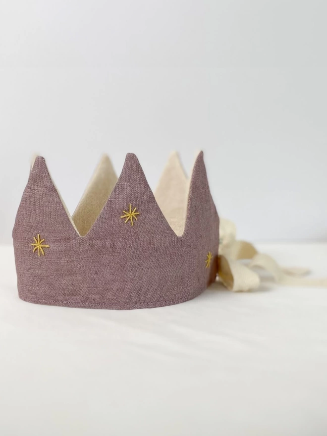 Dusty Lilac crown with hand-stitched stars from the side.