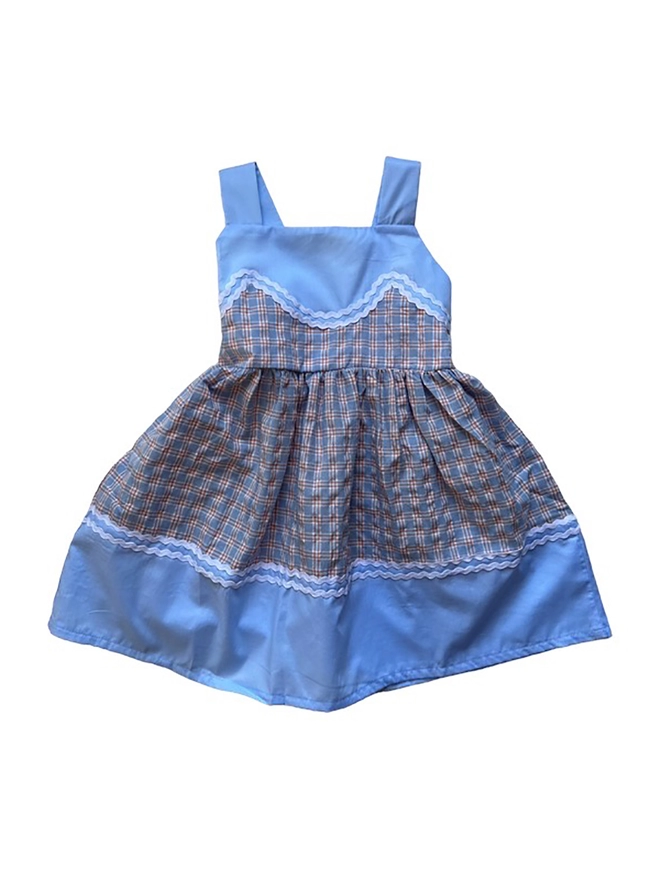 A sundress with blue checked fabric, plain blue fabric and rikrak detail