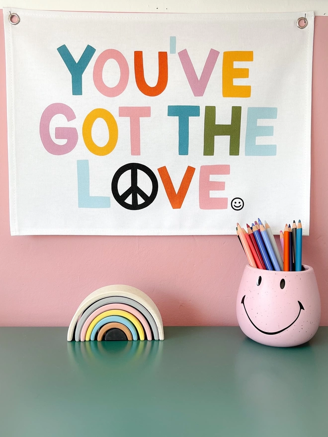 You’ve got the love wall banner on a pink background wall