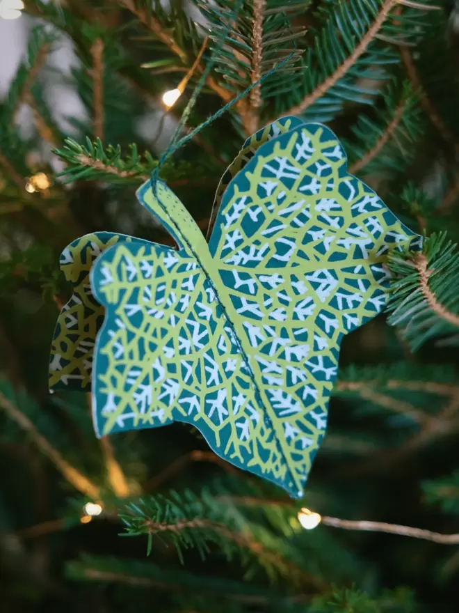 Close-up, detailed shot: 3D paper decoration hanging on christmas tree