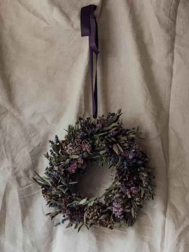 Dried Flower Wreath on a white Wall. Dried flowers such as Sweet Williams and Sage