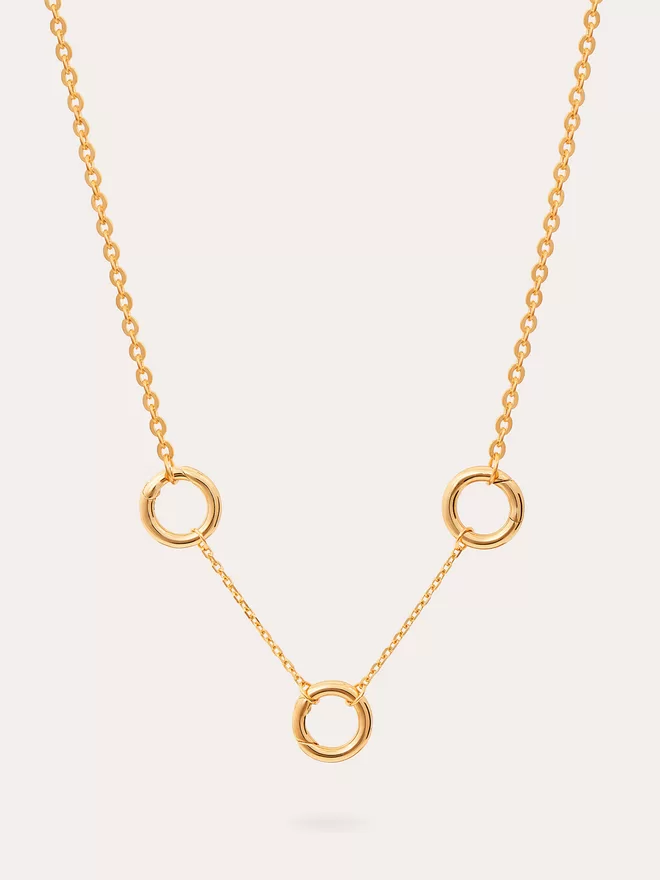 still life of a triple Link Fine Mixed Chain gold Necklace