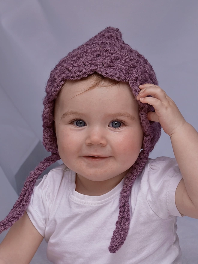 Baby wearing scallop edge hat