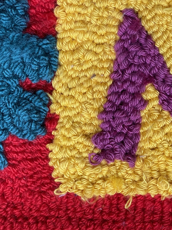 blue yellow, purple and red woollen loops