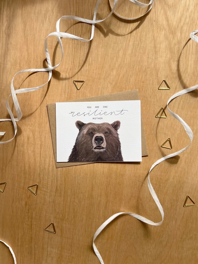a greetings card featuring the face of a brown bear with the phrase “you are one resilient mother”
