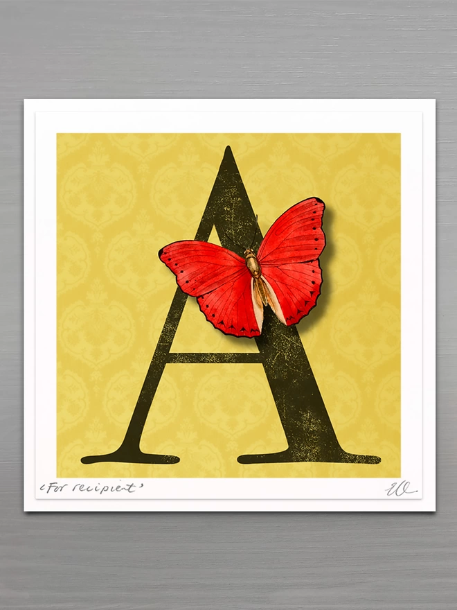 personalised birthday card with large letter on a gold coloured patterned background with a 3D paper cut butterfly   