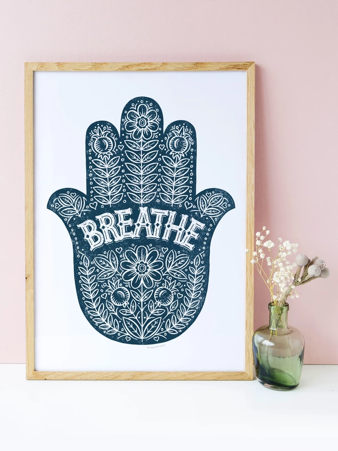 blue and white yoga hand print in wood frame with pink background