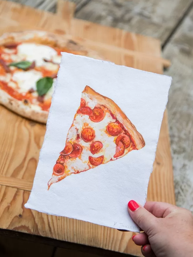 Katie Tinkler illustration of a Pizza Slice seen in front of Pizza.