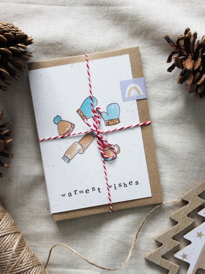 'An Eco-Friendly Christmas' Card pack being shown as it would be delivered, in red and white twine