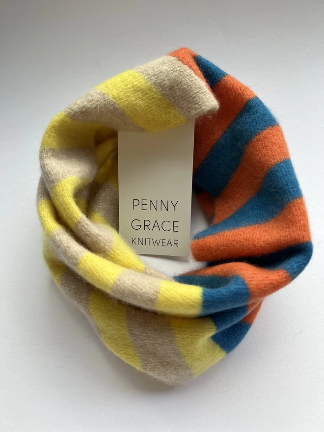 Blue Orange Yellow knitted snood shown from above on a white background