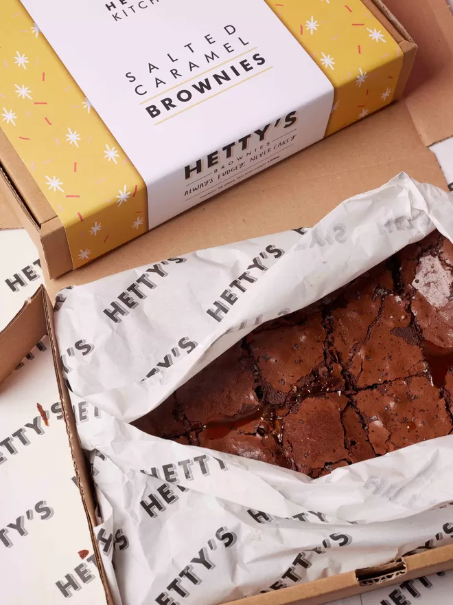 Ten slices of sea salted caramel brownies packaged up in a branded box
