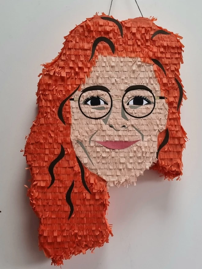 portrait pinata of a woman with ginger hair and glasses