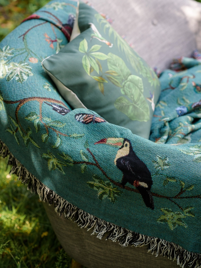Detail of the Forest Flight Blanket by Arcana showing a pelican and tree.