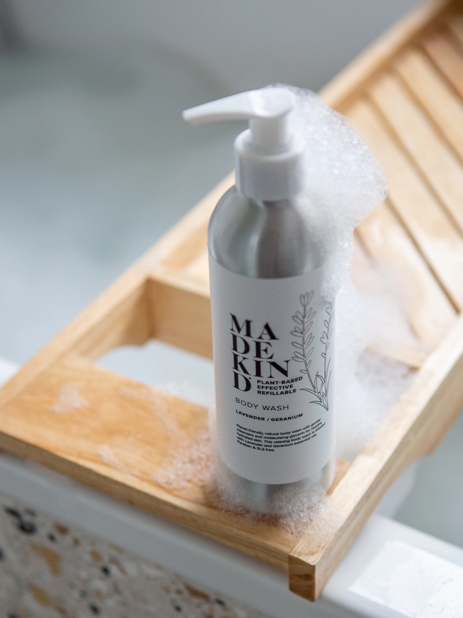 Body wash on side of bath with foam