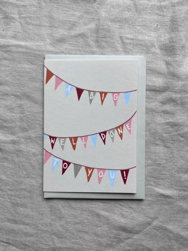 a greetings card with bunting on to celebrate and say a big well done! 