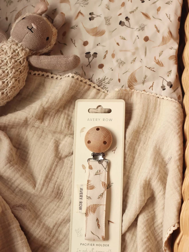 A sheep rattle and a pacifier holder