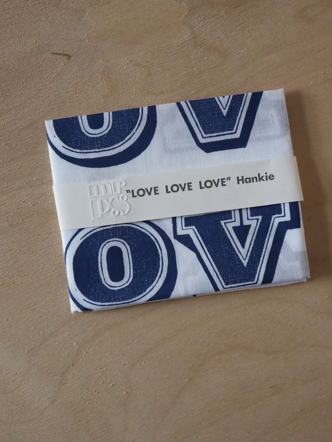 A folded Mr.PS LOVE hankie printed in midnight blue. 