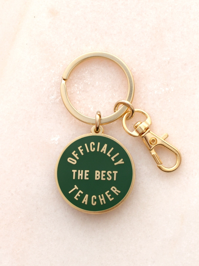 green keyring with 'officially the best teacher' design