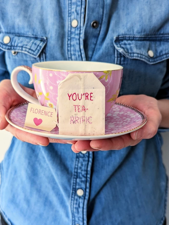 Embroidered You're tea-rrific teabag on cup and saucer 