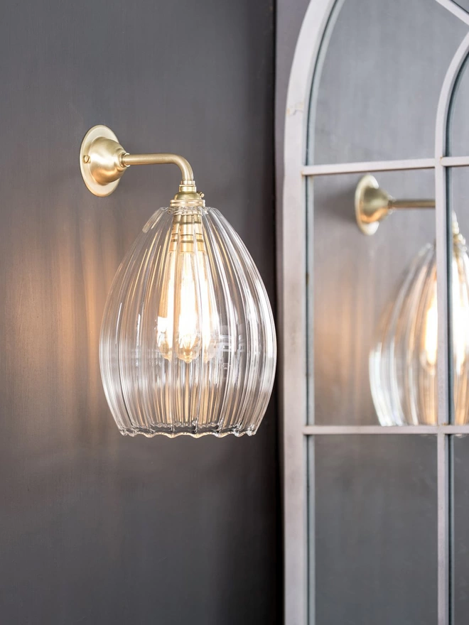 Medium Clear Ribbed Glass Molly Wall Light On A Brushed Brass Wall Light 