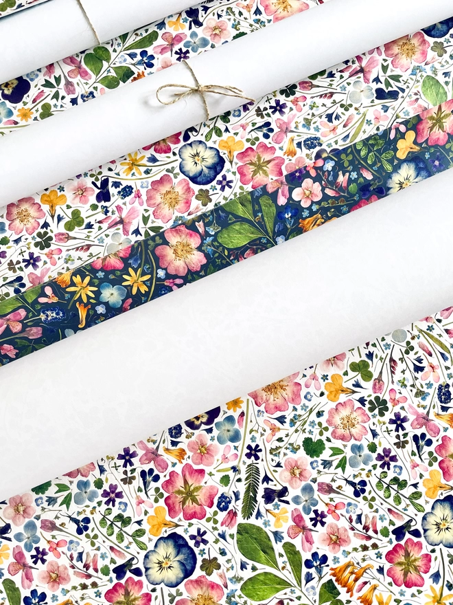 Collection of eco-friendly floral gift wraps with pressed flowers, including Hydrangea, Viola, Cornflower, Lavender, Pink Dog-Rose, Daisy, Verbena, Buttercup, and Forget-Me-Not