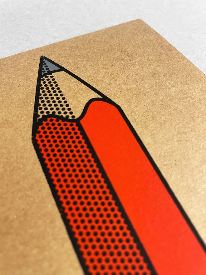 Close up of a red pencil design screenprinted onto brown Kraft card, with black outline and half tone detail.