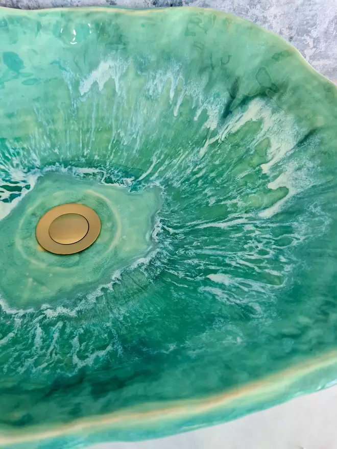 Turquoise green bathroom basin atop a marble countertop with gold taps, bathroom, wc, ensuite, sink, ceramic basin, Jenny Hopps Pottery, J.Hopps Pottery, J.H Pottery, Homeware, Bathroom decor, interior design, front view, close up glaze detail
