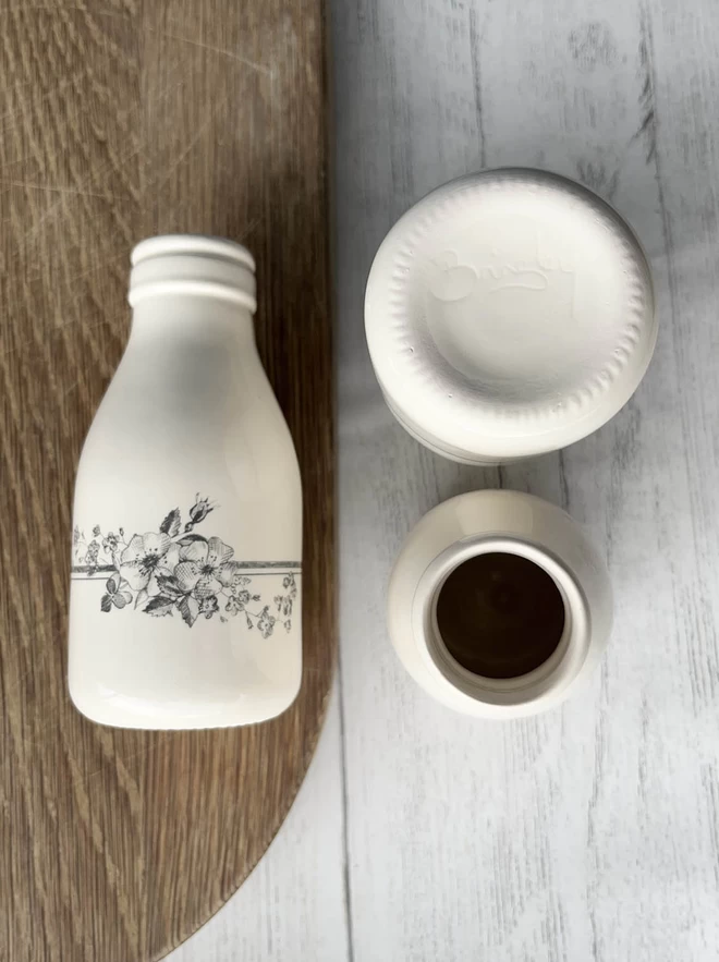 3 ceramic bottles showing views from above, side and with Brinsley signed on its base. 