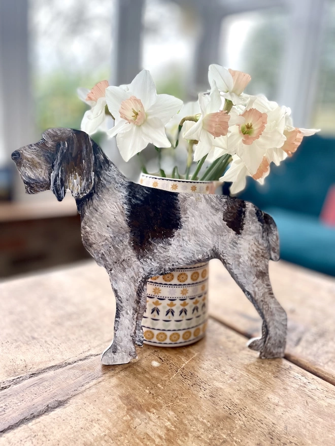 Italian Spinone wooden handpainted dog portrait stood up next to a jar of flowers