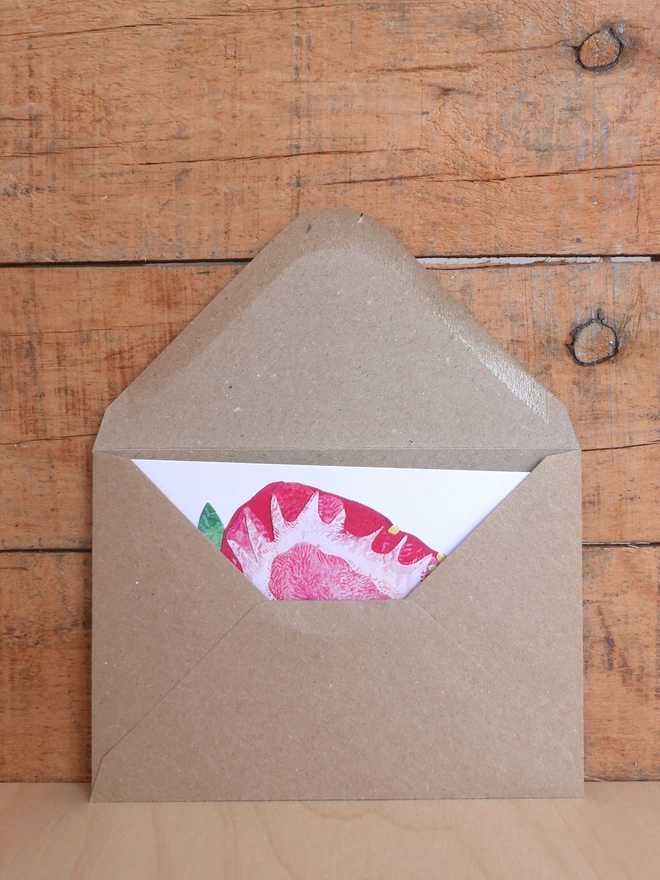 The Strawberry Heart Card inside brown envelope with triangular flap open revealing glimpse of berry