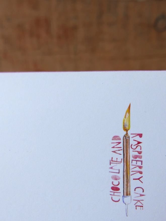 A close up of the illustration on the back of the card showing a birthday candle on white background