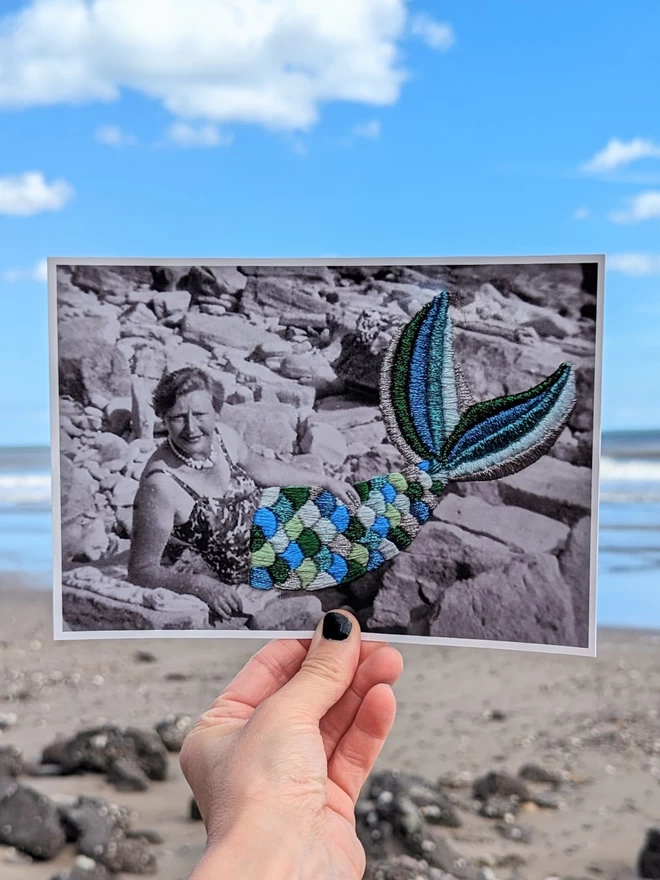 B&W image of woman with embroidered mermaid tail with beach background
