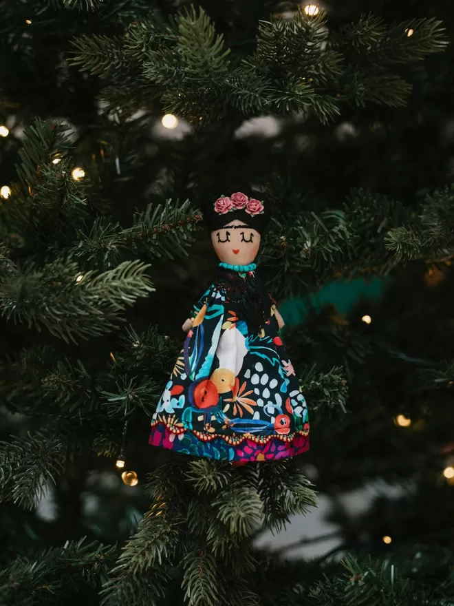 Jennifer Jackson Frida Khalo doll seen in a tree.