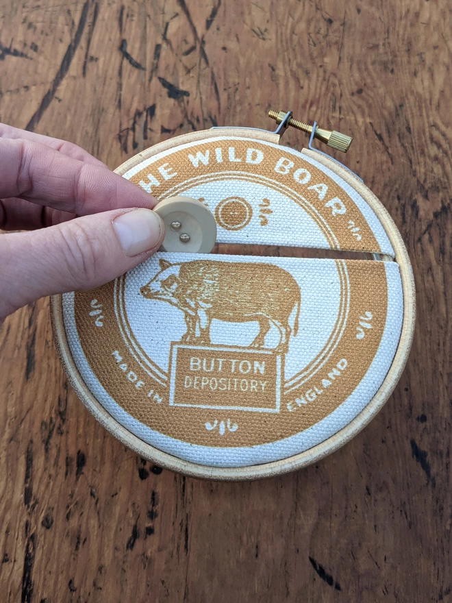 dropping a button into mustard 'Wild Boar' Button Jar