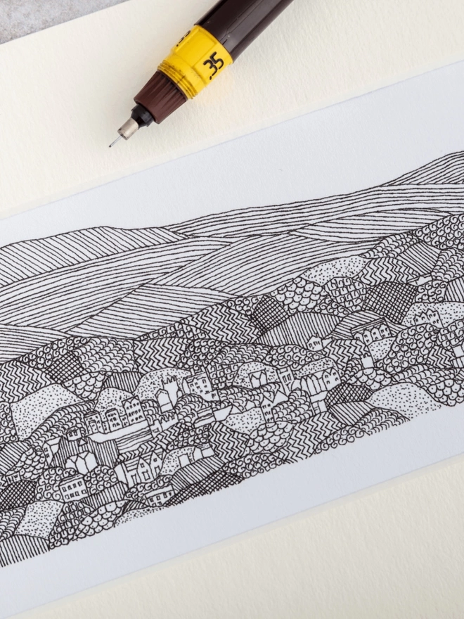Print of a detailed black and white pen and ink drawing of Great Malvern and Malvern hills, in a soft white mount