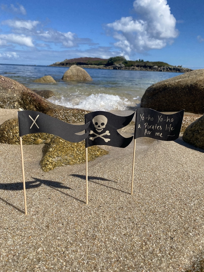 A few pirate flags stuck into the sand