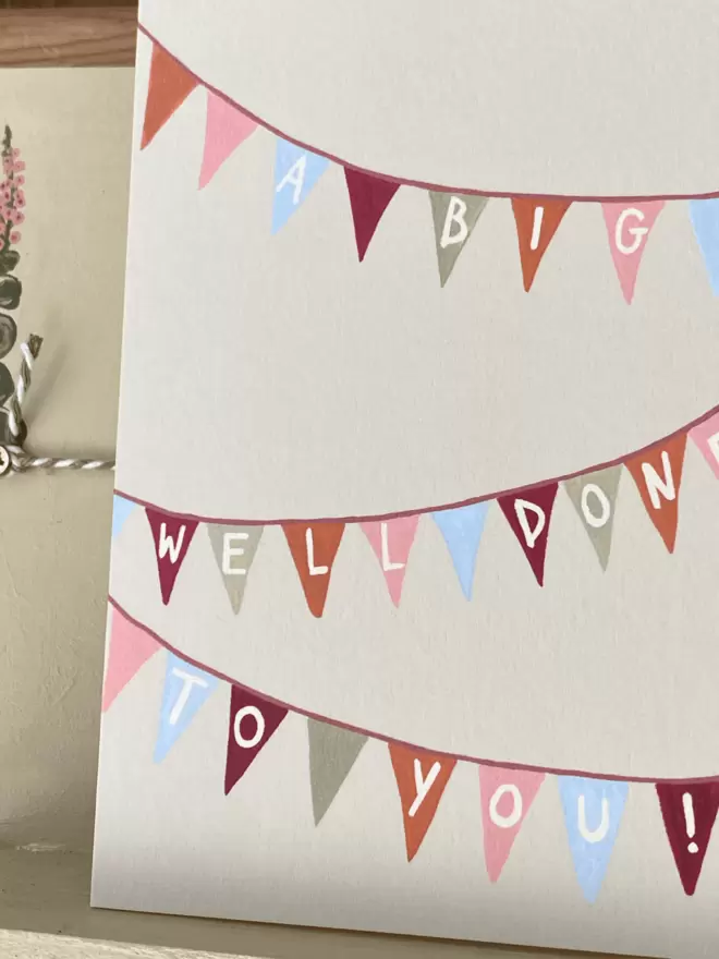 a greetings card with bunting on to celebrate and say a big well done! 