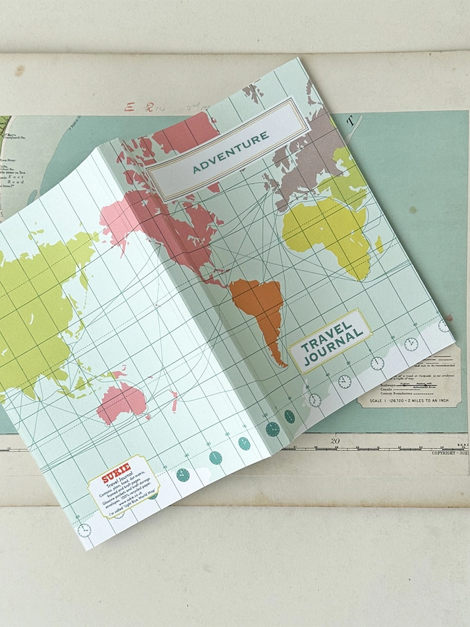 open cover of world map travel journal