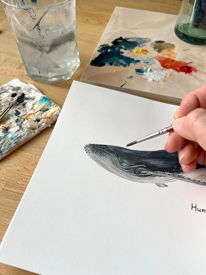 Behind the scenes illustration of a humpback whale being painted